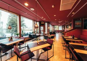 萨翁林纳赌场Spa酒店的餐厅设有桌椅和窗户。