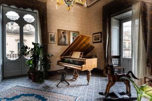 莫迪卡骑士王二世宫殿魅力住宿加早餐酒店的窗户间内有钢琴的房间