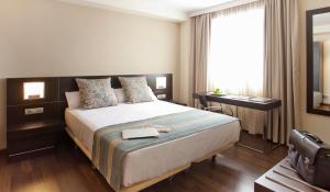 阿尔赫西拉斯Sercotel Aura Algeciras的酒店客房设有床和窗户。