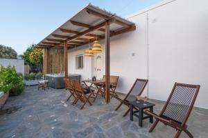 阿达玛斯Kallia's Suites Milos的一个带桌椅和烧烤架的庭院