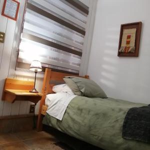 普孔B&B HMüller的一间卧室配有一张床、一张桌子和一个窗户。