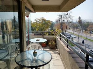 圣地亚哥Habitaciones en Departamento的阳台配有桌椅,享有街道的景色。
