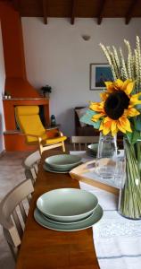 KondárainaLily Home_Lefkada ~ Private Country house的一张带绿板的桌子和一个带向日葵的花瓶