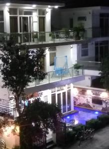 岑山Biệt thự Sao Biển - SB118 FLC Sầm Sơn Resort的一座公寓楼,晚上设有游泳池