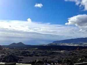 Las ManchasCASA CUEVA DE LAS PALOMAS 1的享有山脉和湖泊的城市美景。