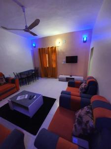 巴马科Appartement Meuble AU GOLF Bamako的带沙发、桌子和电视的客厅