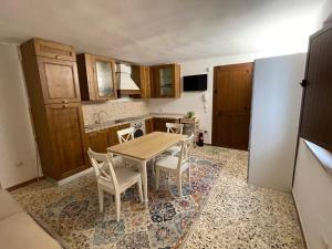 普蒂尼亚诺Trulli Ulivi的厨房配有木桌和椅子