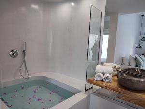 伊奥斯乔拉Drimoni Boutique的浴室配有浴缸、淋浴和水槽