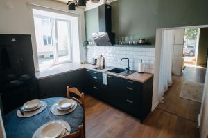 维尔扬迪Hubane korter Viljandi vanalinnas的厨房配有桌子、水槽和窗户