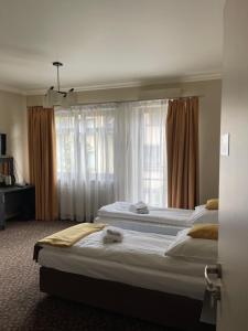 奥尔库什Apartamenty Centrum的酒店客房设有两张床和窗户。