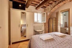 蒙特普齐亚诺La finestra - centro storico Montepulciano, casa panoramica.的一间卧室配有一张床,上面有两条毛巾