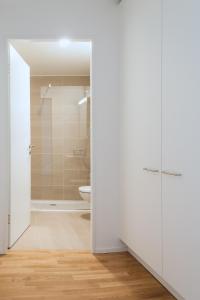 巴塞尔HITrental Messe Apartments的带淋浴和卫生间的白色浴室
