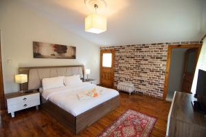 特拉布宗河村别墅的一间卧室设有一张床和砖墙