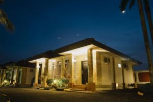 丹戎槟榔丹戎槟榔舒适酒店的夜晚有灯光的外墙的房子