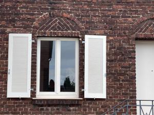 梅尔布施Green46的两扇窗户,带白色百叶窗,位于砖砌建筑内