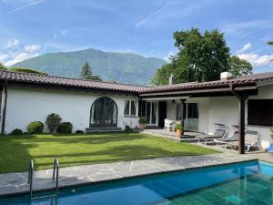 阿斯科纳Casa Via Saleggi 10的庭院中带游泳池的房子