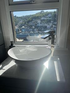 西卢港Penwyn Bed and Breakfast的一间带大窗户和白色浴缸的浴室