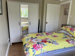 克鲁Yew Tree Bungalow, Onneley, Cheshire的一间卧室配有一张带五颜六色棉被的床
