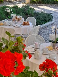 特拉西梅诺湖畔帕西尼亚诺莫提格拖公园公寓的一张桌子,上面放着食物和红花