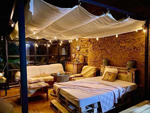 Villar de los BarriosCasa Rural Pico del Lugar的一间卧室配有一张带天蓬和沙发的床