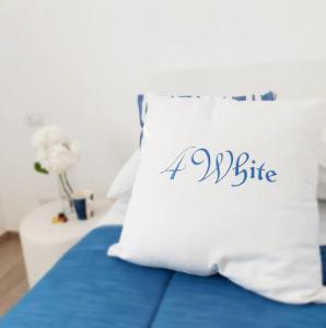阿杰罗拉FOUR WHITE APARTMENTS的床上的枕头上写着一点咬