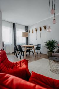 滨湖默尔比施Haus Mörbisch的客厅配有红色的沙发和桌子
