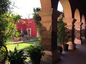 乔卢拉Quinta Luna的一座庭院,里面种有红色的建筑和植物