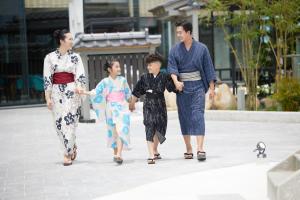 岘港Da Nang - Mikazuki Japanese Resorts & Spa的三人行走在人行道上