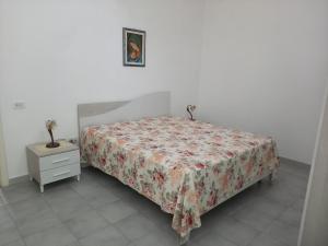 切萨雷奥港Casa Giada的一间卧室配有一张床和一个带床罩的梳妆台
