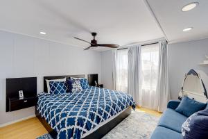 大洋城The Quarterdeck OC的一间卧室配有蓝色的床和蓝色的沙发