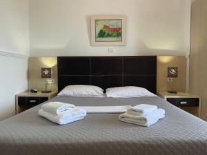 佩弗奇加里尼酒店的一间卧室配有带毛巾的床