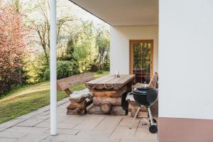 LeitenFerienwohnung Waldgarten的露台上的烧烤架和野餐桌