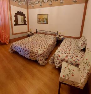 里奥马里纳Appartamento Giallo的一间卧室配有两张床和椅子