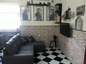马拉加Apartamento La escapada的客厅配有沙发和墙上的照片