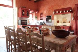 LapaludMaison en Provence的厨房配有木桌和碗