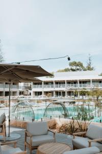 罗特内斯特岛Samphire Rottnest的一个带游泳池和椅子的度假胜地和一座建筑