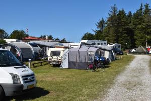 汉斯特霍尔姆Hytteby – Hanstholm Camping – Thy Feriepark的一群帐篷和一群自行车停放在田野里