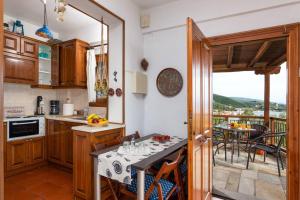 费索斯Seaside House with view over Pagasitikos的一间带桌子的厨房和一个阳台
