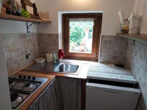 Calasca CastiglioneAdelaide House by casa Shanty的一个带水槽和窗户的小厨房