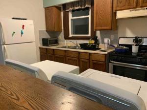 奥斯威戈The Navy 2的厨房配有木制橱柜和白色冰箱。