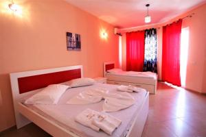 圣金Hotel Comfort的一间卧室设有两张床和红色窗帘