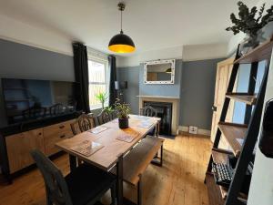 贝里圣埃德蒙兹Charming 3 bedroom property in Bury St Edmunds的一间带桌子和壁炉的用餐室
