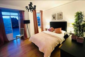 伦敦Luxury 3 bedroom 3 and a half bathroom flat in Swiss Cottage的一间卧室设有一张床和一个大窗户