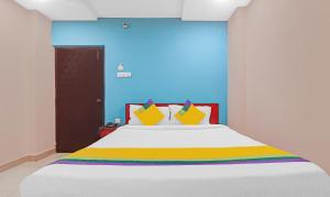 海得拉巴Itsy By Treebo - Aflah的卧室配有一张带彩色枕头的大型白色床。