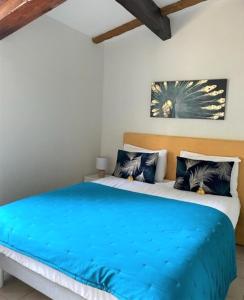 韦尔东的圣克鲁瓦auberge du castellas的一间卧室配有一张带蓝色毯子的床
