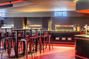 圣安东尼奥Hotel Vibra District - Adults Only的餐厅内带红色凳子的酒吧