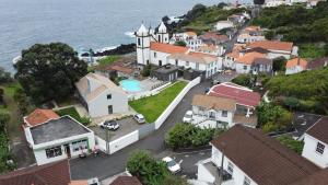 Calheta de NesquimCasa Do Avô Faidoca的享有小镇的空中景致,设有房屋和大海
