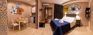 巴里ASTARE -short lets in bari carrassi-的酒店客房设有一张床铺、一张桌子和一间厨房。