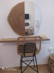 阿波罗尼亚Mantelena studios & family apartments的一张带镜子的架子上的藤椅