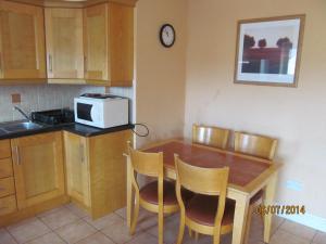 特拉利Holiday Home Tralee Ireland的厨房配有桌椅和微波炉。